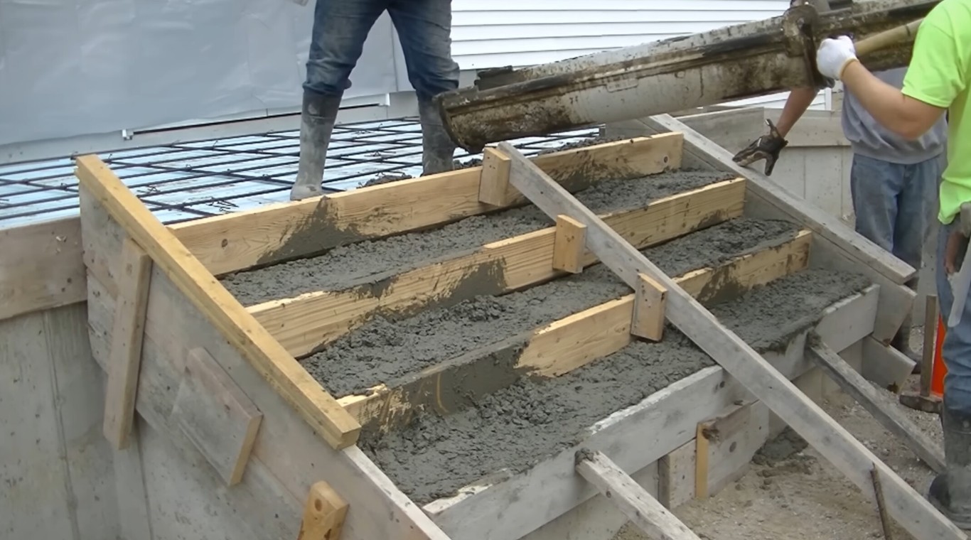 Licensed concrete professionals constructing concrete steps with precision